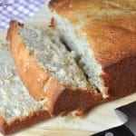 A loaf of sliced Easy Homemade Banana Bread on a wooden board.